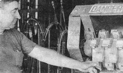 Lloyd Schroeder examines debarking machine