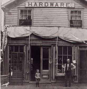 Marengo hardware store-front with Johnson Dean? and child