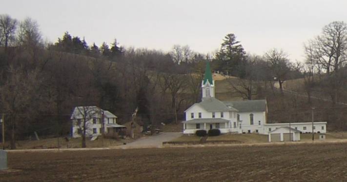 Elkport Lutheran Church & Parsonage, showing the cemetery in the background